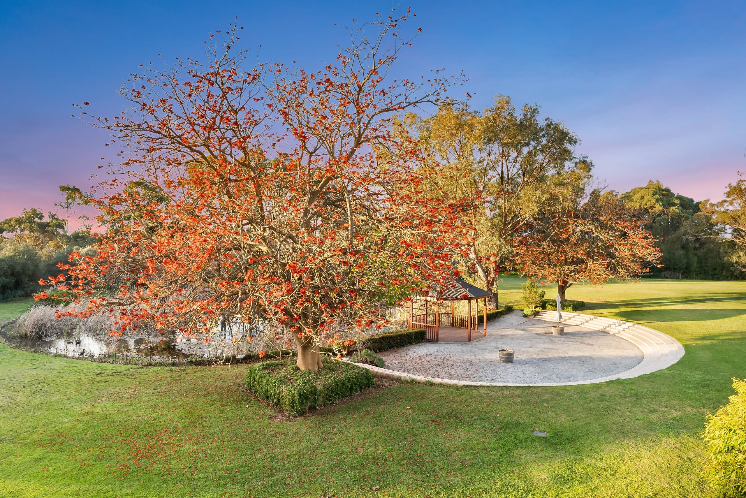 Wooden gazebo beside the pond, surrounded by autumn colour
